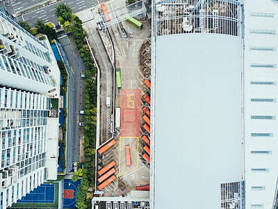 aerial photography of parking lot beside gray building thumbnail