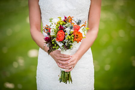 woman in white dress holding bouquet of flowers thumbnail