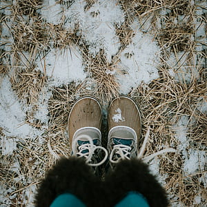 person wearing pair of brown shoes standing on snow thumbnail