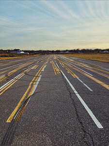 gray asphalt road under blue sky thumbnail