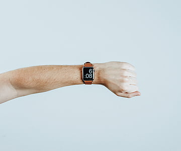 person wearing silver smartwatch displaying 6:08 thumbnail