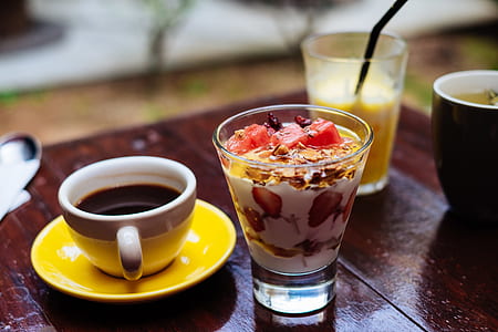 white ceramic mug beside clear glass on brown wooden table thumbnail