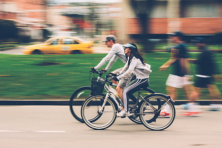 woman riding white rigid bike beside man riding black bike thumbnail