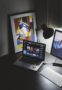 MacBook Pro on black wooden table thumbnail
