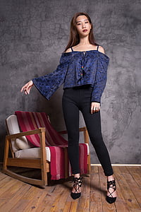 woman wearing blue long-sleeved shirt and black pants thumbnail