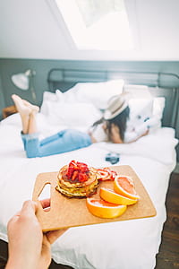 person holding chopping board with pancake and sliced melon thumbnail