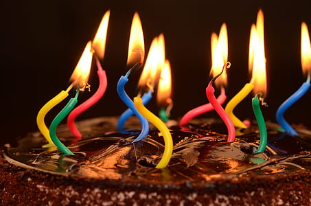 lit assorted-color cake candles thumbnail
