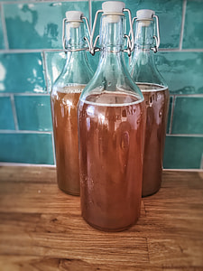 three clear glass bottles filled with brown liquids thumbnail