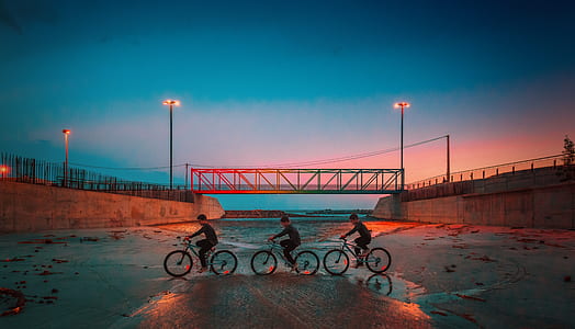 photography of three person riding in bicycle thumbnail
