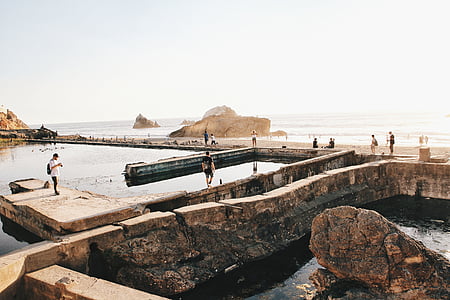group of people on gray rock formation thumbnail