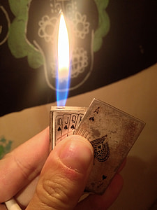 person holding playing card-themed Zippo flip lighter thumbnail