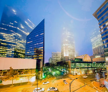 high-rise buildings and cars under blue sky thumbnail