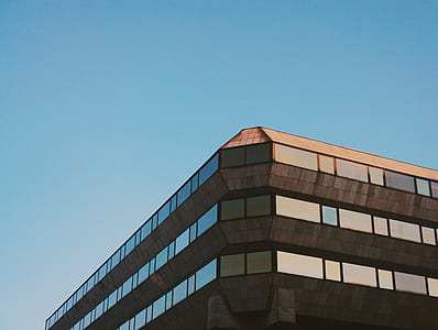 worm's-eye view of building under blue sky thumbnail