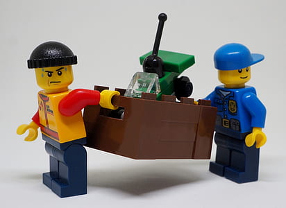 close-up photography of two assorted-color Lego minifigs thumbnail