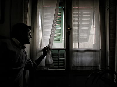 man looking out the window thumbnail