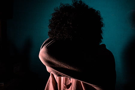 woman standing while covering her face with her elbow thumbnail