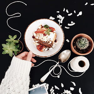Woman Touching White and Brown Ceramic Saucer With Strawberry Cake thumbnail