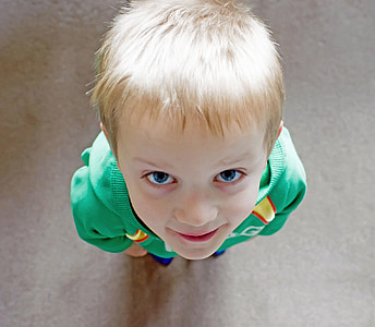 closeup photo of boy looking on camera thumbnail