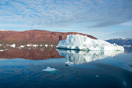 ice berg on the water under blue sky photography thumbnail