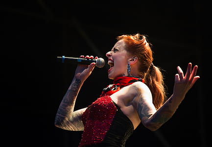 woman in red and black top singing thumbnail