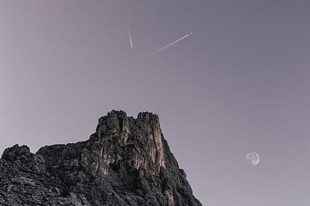 Two Planes Flying over Rock Formation at Dawn thumbnail