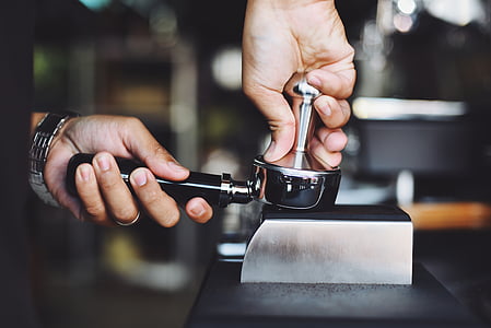 person holding black and silver kitchen utensil thumbnail
