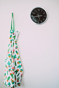 White and Green Cactus Pattern Apron Near Round Gray Analog Wall Clock thumbnail