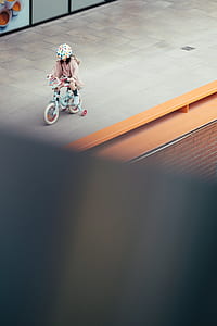 girl riding on teal training bicycle thumbnail