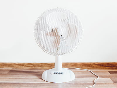 turned-off white desk fan on floor thumbnail