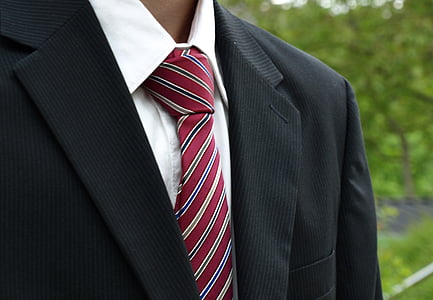 closeup photo of man wearing black notched lapel suit jacket thumbnail