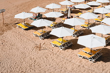photo lounger chairs with umbrellas under the sun thumbnail