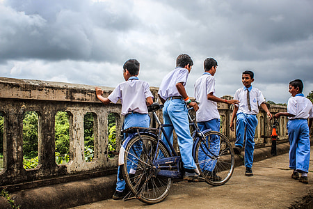 five boys standing near gray concrete rails during cloudy day thumbnail