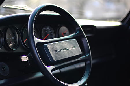 closeup photo of black Porsche steering wheel thumbnail