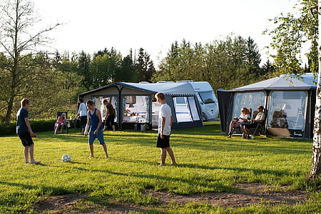 people on grass field near TV trailers thumbnail