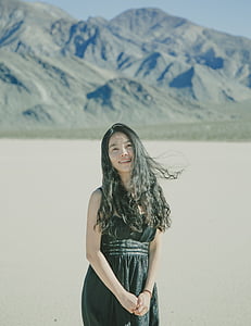 woman standing near gray mountain thumbnail
