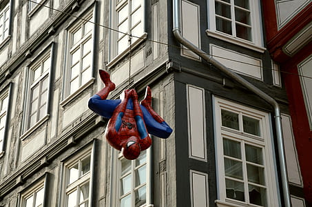 red and blue Spider-Man hanging decor on street at daytime thumbnail