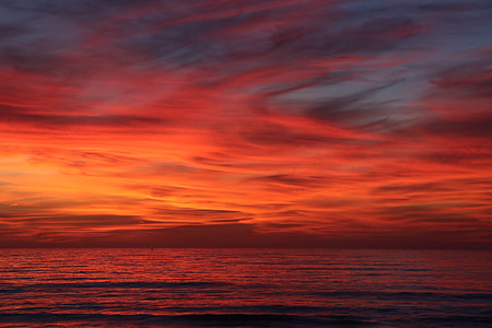 A red sky sunset over the ocean thumbnail