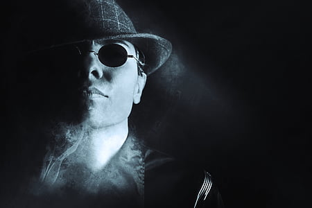 man in round hat with smoke and sunglasses thumbnail
