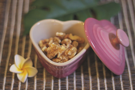 selective focus photography of nuts on heart-shape pink ceramic container thumbnail