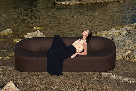woman in black and brown dress on sofa thumbnail