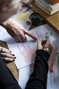 Person Writing on White Printer Paper on Beige Wooden Table thumbnail