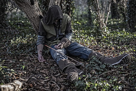 man sitting while leaning on tree thumbnail