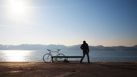 man standing near road bike thumbnail