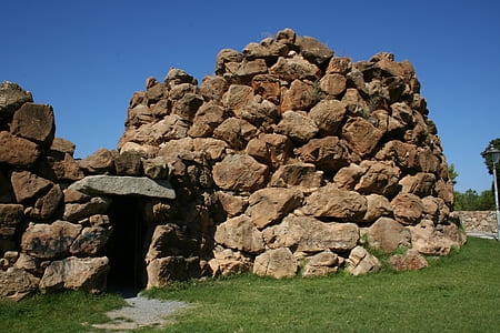 brown stone cave under clear blue sky thumbnail