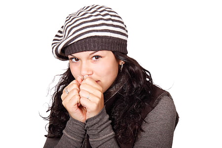 Woman in White and Black Stripe Cap and Grey Shirt Hands to Face thumbnail