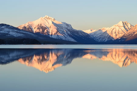 mountain covered by snow under blue sky thumbnail