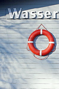 red and white lifebuoy on wall thumbnail