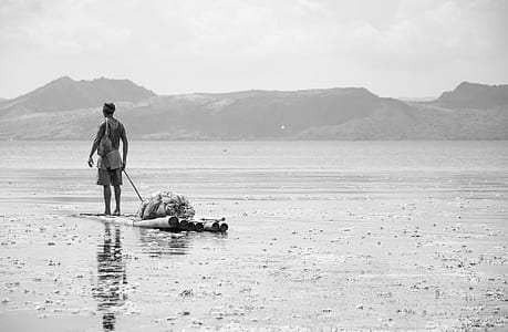 grayscale photography of man standing on bamboo thumbnail