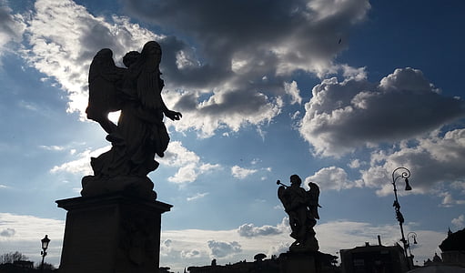 two angel statues under white clouds thumbnail
