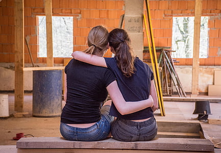 two women wearing black short-sleeved shirts thumbnail